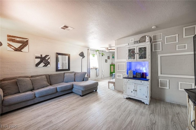 108 Verdy Ln, Las Vegas, NV 89101 - living area featuring wood finished floors, a textured ceiling, and a ceiling fan