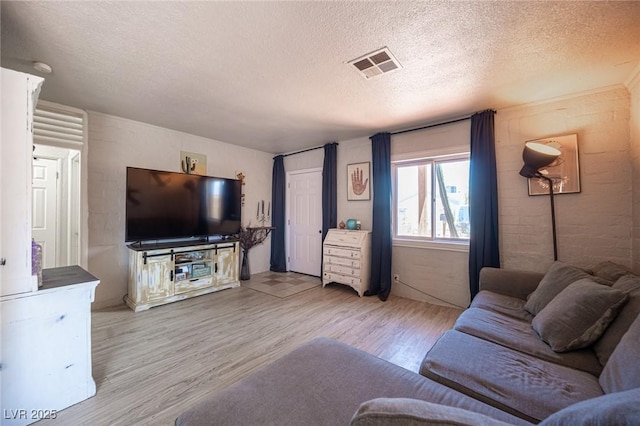 108 Verdy Ln, Las Vegas, NV 89101 - living room featuring light wood-style floors and a textured ceiling