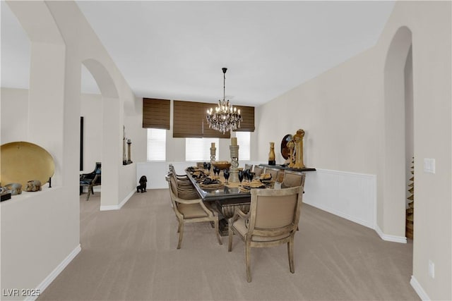 6739 Quapaw St, Las Vegas, NV 89149 - dining room with arched walkways, light colored carpet, a chandelier, and baseboards