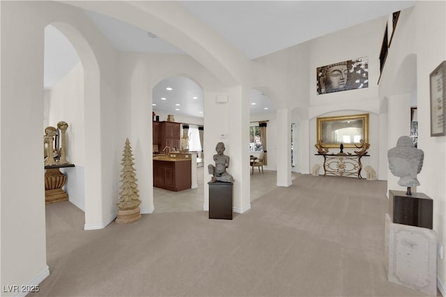 6739 Quapaw St, Las Vegas, NV 89149 - foyer entrance with light colored carpet, baseboards, recessed lighting, and arched walkways