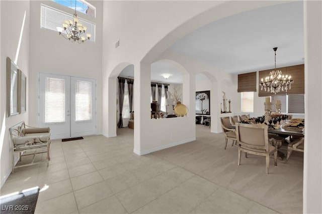 6739 Quapaw St, Las Vegas, NV 89149 - foyer with a chandelier, arched walkways, light tile patterned flooring, and baseboards