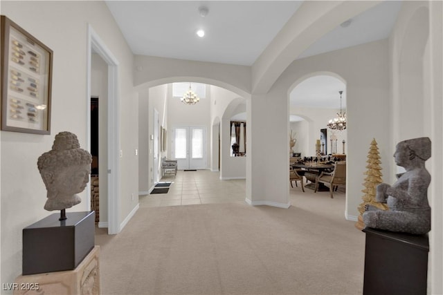 6739 Quapaw St, Las Vegas, NV 89149 - hall with arched walkways, a chandelier, light colored carpet, and baseboards