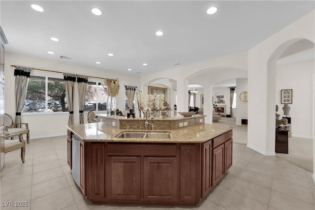 6739 Quapaw St, Las Vegas, NV 89149 - kitchen with a sink, an island with sink, light tile patterned flooring, light stone countertops, and recessed lighting