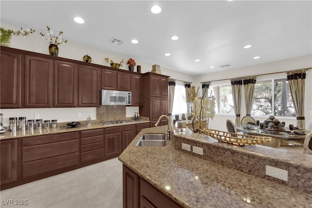 6739 Quapaw St, Las Vegas, NV 89149 - kitchen with stainless steel appliances, a sink, light stone counters, recessed lighting, and light tile patterned floors