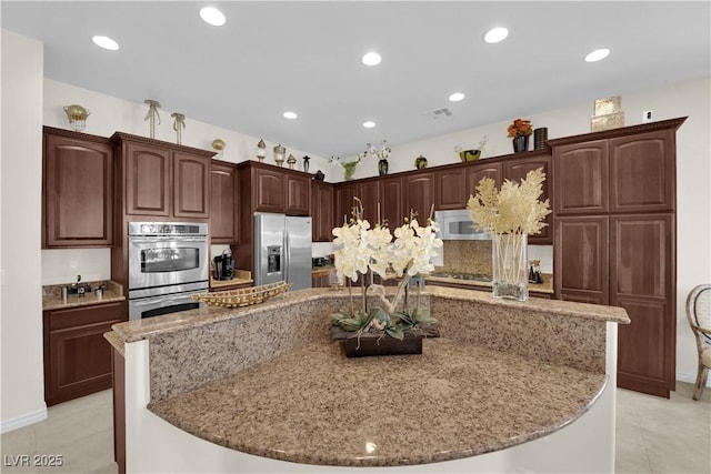 6739 Quapaw St, Las Vegas, NV 89149 - kitchen featuring appliances with stainless steel finishes, a large island, light stone counters, light tile patterned flooring, and recessed lighting