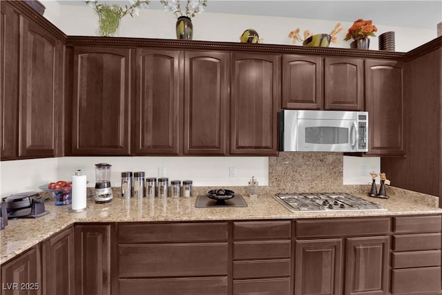6739 Quapaw St, Las Vegas, NV 89149 - kitchen featuring stainless steel appliances, dark brown cabinetry, and light stone counters