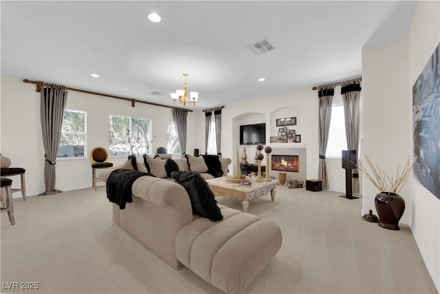 6739 Quapaw St, Las Vegas, NV 89149 - living area featuring a glass covered fireplace, a chandelier, light carpet, recessed lighting, and baseboards