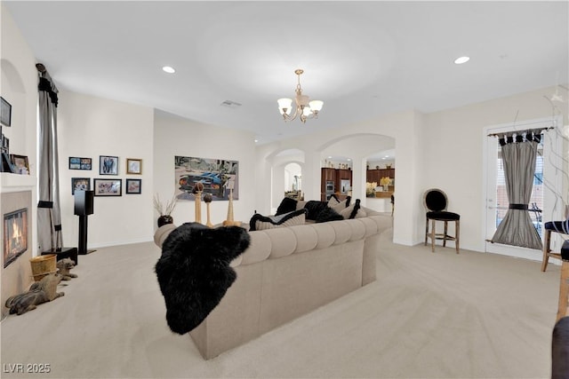 6739 Quapaw St, Las Vegas, NV 89149 - carpeted living room with arched walkways, recessed lighting, a chandelier, a tile fireplace, and baseboards