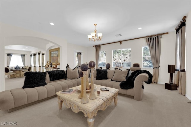 6739 Quapaw St, Las Vegas, NV 89149 - living room featuring a chandelier, light carpet, arched walkways, and recessed lighting