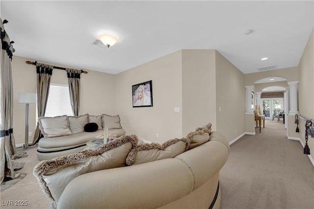 6739 Quapaw St, Las Vegas, NV 89149 - living room with ornate columns, arched walkways, light colored carpet, and baseboards