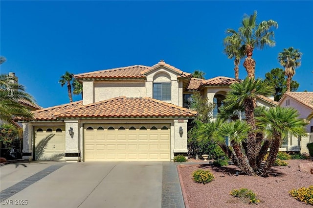 2917 Broken Willow Cir, Las Vegas, NV 89117 - mediterranean / spanish home with concrete driveway, stucco siding, a tiled roof, and an attached garage