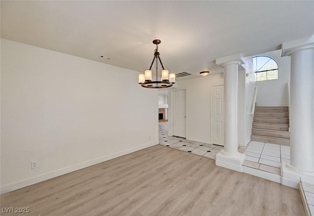 2917 Broken Willow Cir, Las Vegas, NV 89117 - spare room with decorative columns, light wood finished floors, a chandelier, stairs, and baseboards