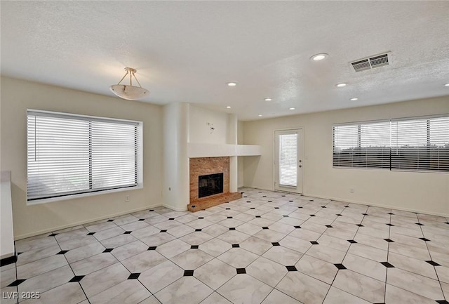 2917 Broken Willow Cir, Las Vegas, NV 89117 - unfurnished living room with a fireplace, baseboards, recessed lighting, and a textured ceiling