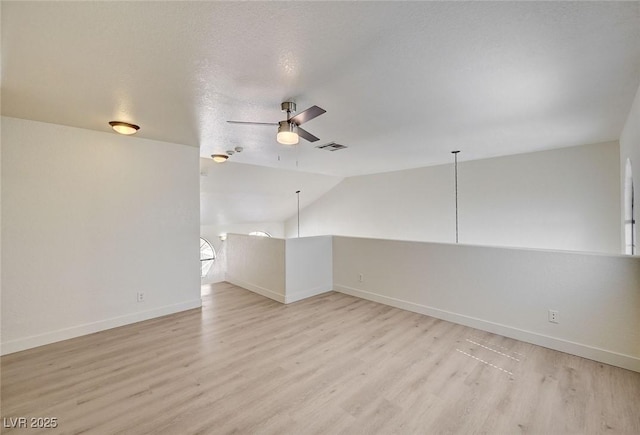2917 Broken Willow Cir, Las Vegas, NV 89117 - empty room featuring light wood-style flooring, a ceiling fan, baseboards, and lofted ceiling