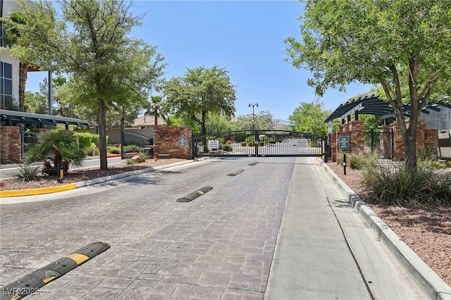 11707 Longworth Rd, Las Vegas, NV 89135 - view of decorative street featuring a gate, curbs, and a gated entry
