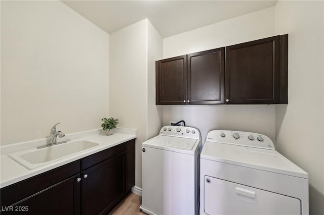 11707 Longworth Rd, Las Vegas, NV 89135 - laundry room with cabinet space, independent washer and dryer, and light wood-type flooring