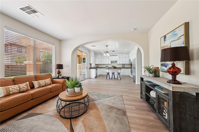 11707 Longworth Rd, Las Vegas, NV 89135 - living room with light wood-style floors, arched walkways, and baseboards