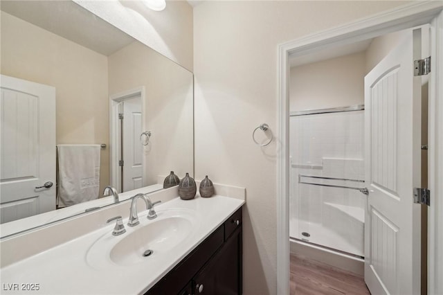 11707 Longworth Rd, Las Vegas, NV 89135 - bathroom with vanity, a stall shower, and wood finished floors