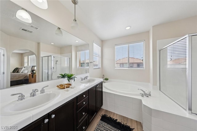 11707 Longworth Rd, Las Vegas, NV 89135 - ensuite bathroom featuring a shower stall, a bath, double vanity, and healthy amount of natural light