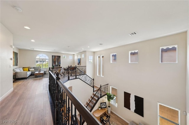 11707 Longworth Rd, Las Vegas, NV 89135 - hallway with an upstairs landing, wood finished floors, recessed lighting, and baseboards