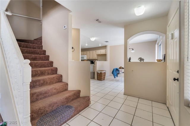3950 S Sandhill Rd Unit 130, Las Vegas, NV 89121 - foyer featuring arched walkways, light tile patterned floors, and stairs
