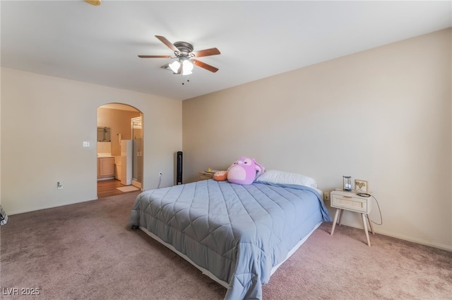 3950 S Sandhill Rd Unit 130, Las Vegas, NV 89121 - carpeted bedroom featuring arched walkways, ensuite bath, and ceiling fan