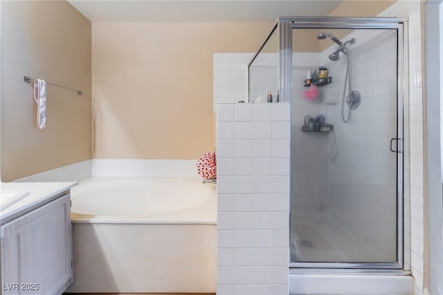 3950 S Sandhill Rd Unit 130, Las Vegas, NV 89121 - full bath featuring a bath, a shower stall, and vanity