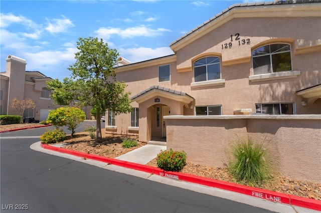 3950 S Sandhill Rd Unit 130, Las Vegas, NV 89121 - view of property with stucco siding and a tiled roof
