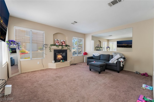 3950 S Sandhill Rd Unit 130, Las Vegas, NV 89121 - living room featuring carpet floors, a glass covered fireplace, and baseboards