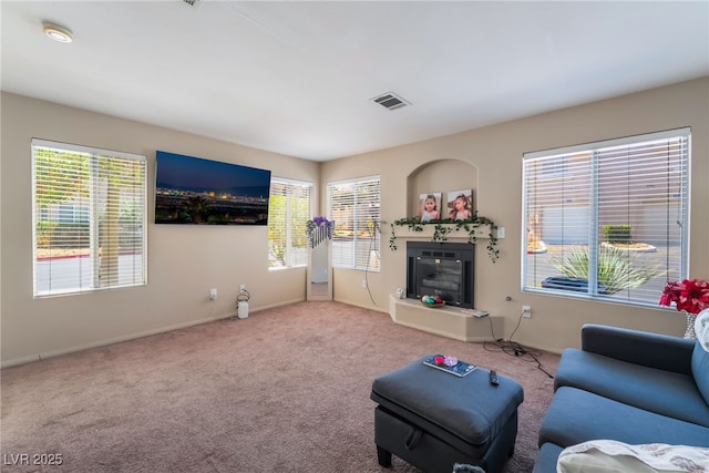 3950 S Sandhill Rd Unit 130, Las Vegas, NV 89121 - living room with carpet flooring, plenty of natural light, and a glass covered fireplace