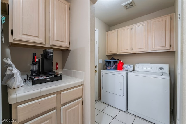 3950 S Sandhill Rd Unit 130, Las Vegas, NV 89121 - washroom with cabinet space, independent washer and dryer, and light tile patterned flooring