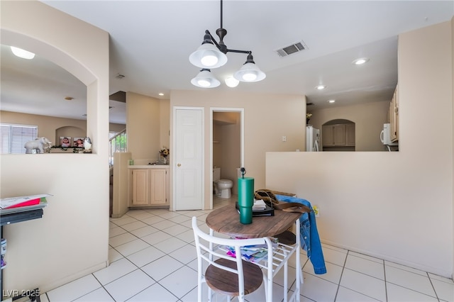 3950 S Sandhill Rd Unit 130, Las Vegas, NV 89121 - dining area featuring a chandelier, light tile patterned floors, arched walkways, and recessed lighting