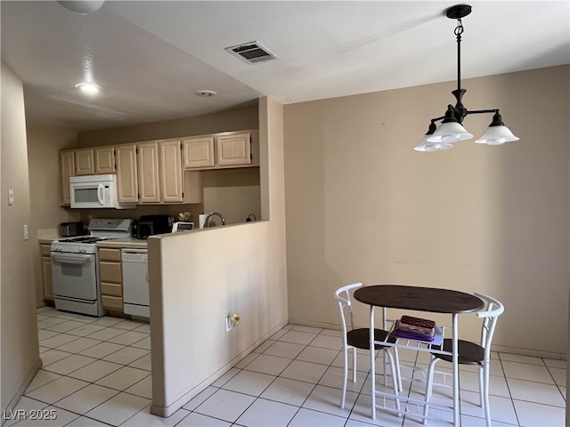 3950 S Sandhill Rd Unit 130, Las Vegas, NV 89121 - kitchen featuring white appliances, light countertops, decorative light fixtures, recessed lighting, and light tile patterned floors