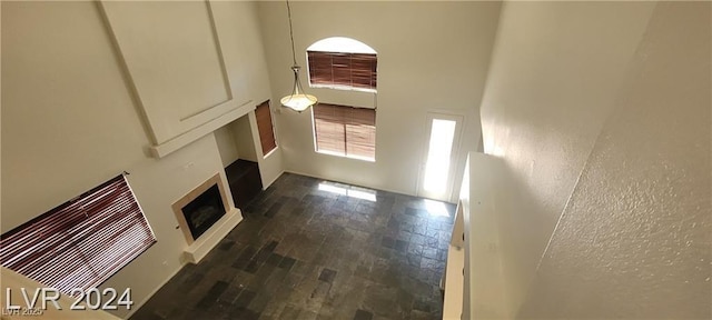 4821 Whisper Lake Ave, Las Vegas, NV 89131 - unfurnished living room with hardwood / wood-style floors, a fireplace, and a towering ceiling