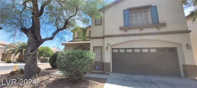 4821 Whisper Lake Ave, Las Vegas, NV 89131 - mediterranean / spanish-style home with stucco siding, a garage, and driveway