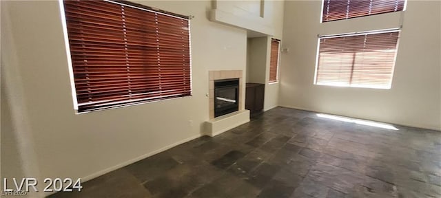 4821 Whisper Lake Ave, Las Vegas, NV 89131 - unfurnished living room featuring a glass covered fireplace and baseboards