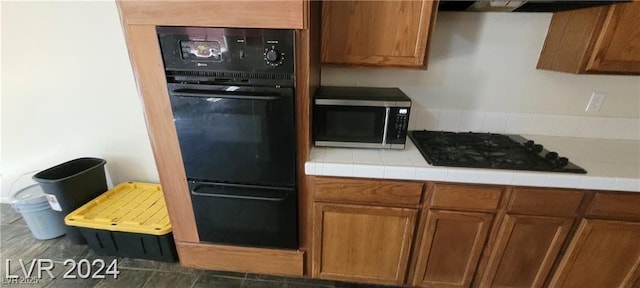 4821 Whisper Lake Ave, Las Vegas, NV 89131 - kitchen featuring black appliances, brown cabinetry, a warming drawer, and range hood