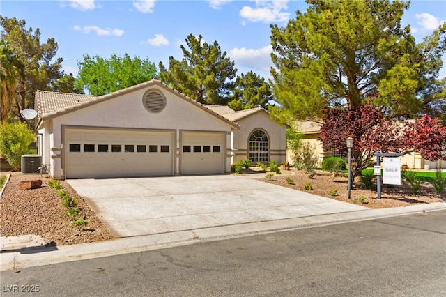 5157 Future Dr, Las Vegas, NV 89130 - view of front facade with a tile roof, stucco siding, driveway, central air condition unit, and a garage