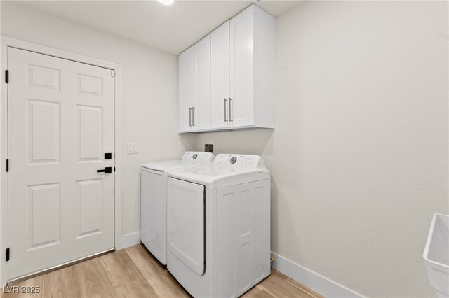 5157 Future Dr, Las Vegas, NV 89130 - washroom with washing machine and dryer, cabinet space, light wood-style floors, and baseboards
