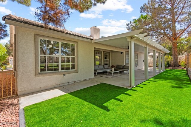 5157 Future Dr, Las Vegas, NV 89130 - back of house with an outdoor living space, a chimney, a patio, and stucco siding