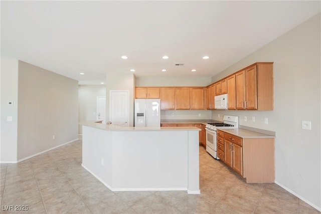 3405 Kingbird Dr, North Las Vegas, NV 89084 - kitchen with white appliances, light countertops, recessed lighting, baseboards, and a center island