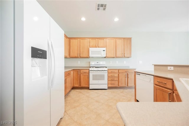 3405 Kingbird Dr, North Las Vegas, NV 89084 - kitchen featuring white appliances, light brown cabinets, light countertops, and recessed lighting