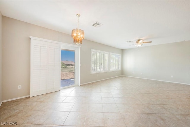 3405 Kingbird Dr, North Las Vegas, NV 89084 - spare room with a ceiling fan, light tile patterned floors, a chandelier, and baseboards