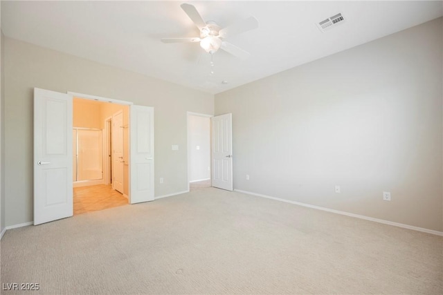 3405 Kingbird Dr, North Las Vegas, NV 89084 - unfurnished bedroom featuring light carpet, baseboards, a ceiling fan, and ensuite bathroom
