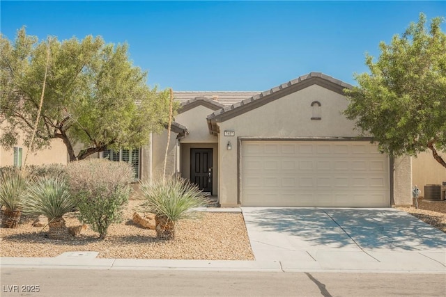 3405 Kingbird Dr, North Las Vegas, NV 89084 - view of front facade with stucco siding, a garage, cooling unit, and driveway