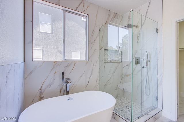 5653 Artesia Lake Ct, Las Vegas, NV 89118 - bathroom featuring tile walls, a marble finish shower, and a soaking tub