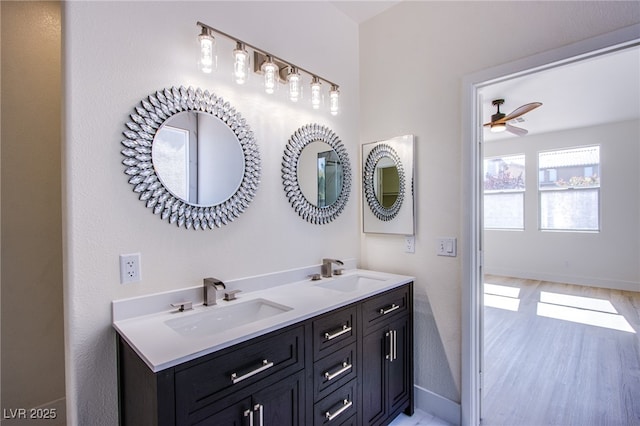 5653 Artesia Lake Ct, Las Vegas, NV 89118 - bathroom with double vanity, baseboards, ceiling fan, and wood finished floors
