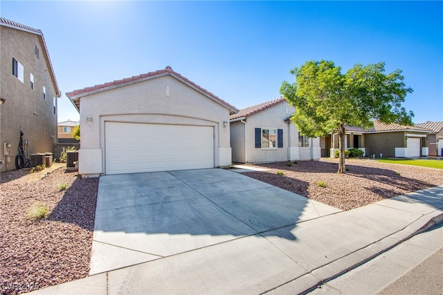 5653 Artesia Lake Ct, Las Vegas, NV 89118 - mediterranean / spanish home featuring concrete driveway, a tile roof, cooling unit, stucco siding, and a garage