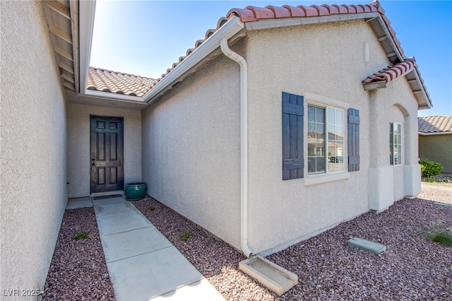 5653 Artesia Lake Ct, Las Vegas, NV 89118 - property entrance featuring a tiled roof and stucco siding