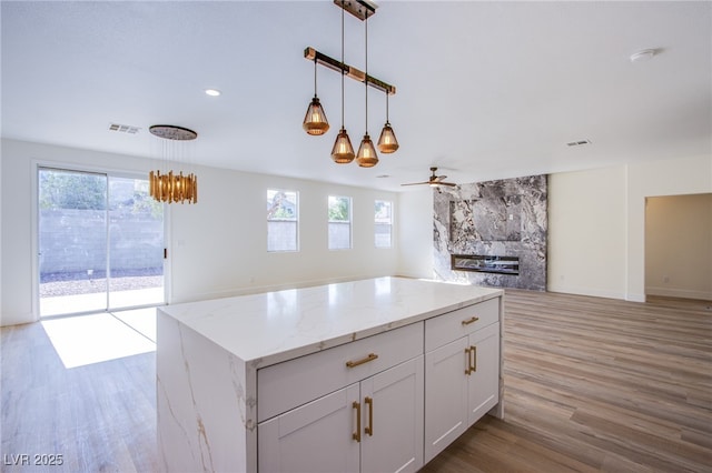5653 Artesia Lake Ct, Las Vegas, NV 89118 - kitchen featuring open floor plan, healthy amount of natural light, light wood finished floors, and recessed lighting